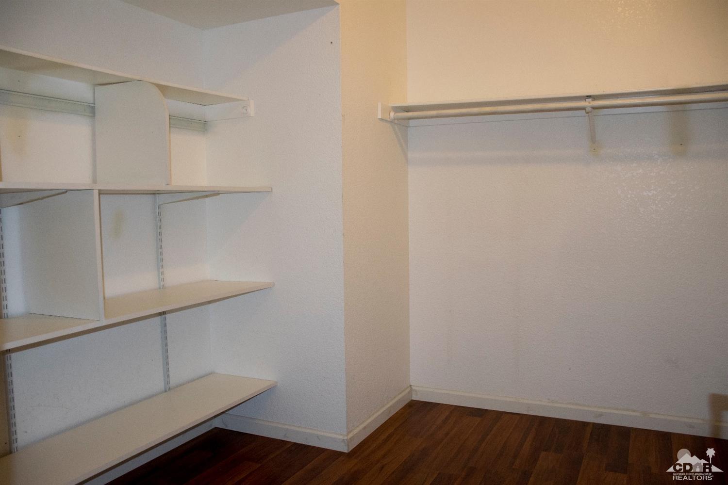 68340 Tortuga Road Cathedral City, CA 92234 - Photo 25 of 37 a view of walk in closet with empty racks
