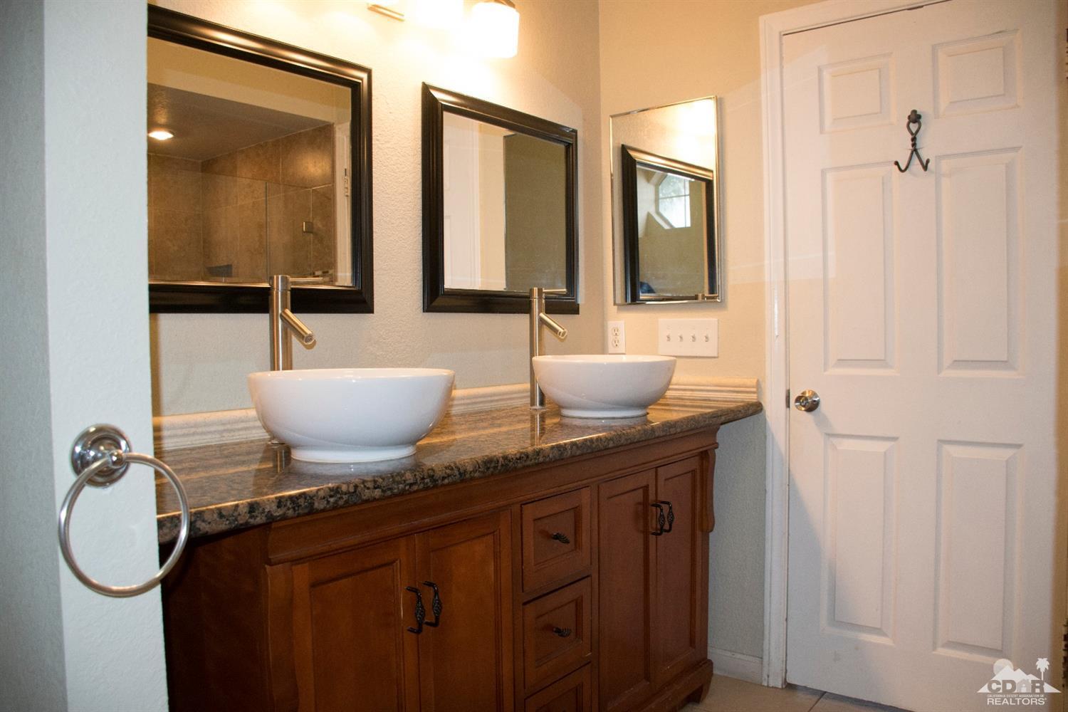 68340 Tortuga Road Cathedral City, CA 92234 - Photo 28 of 37 a bathroom with a granite countertop sink and a mirror