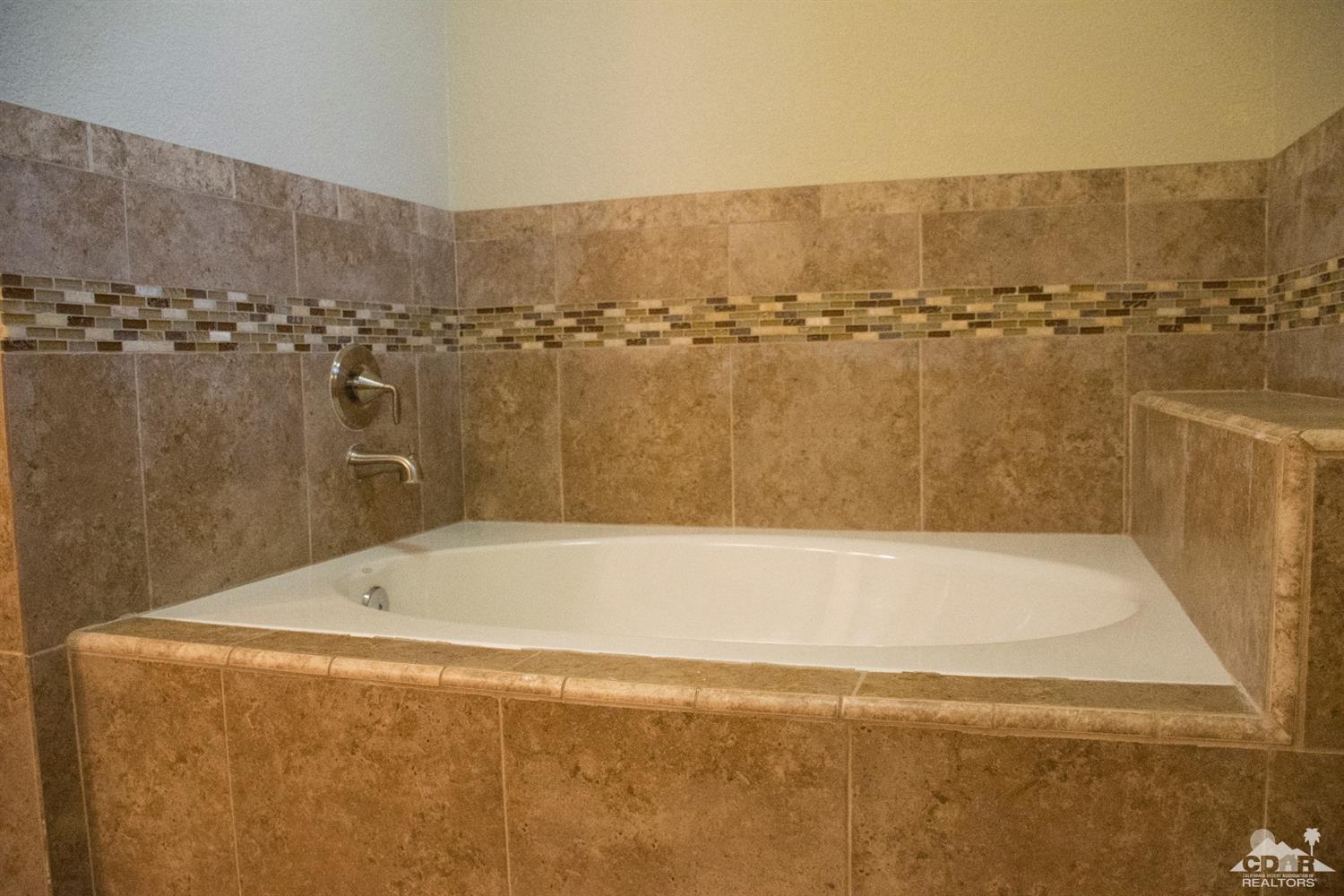 68340 Tortuga Road Cathedral City, CA 92234 - Photo 30 of 37 a bath tub sitting next to a blue sink