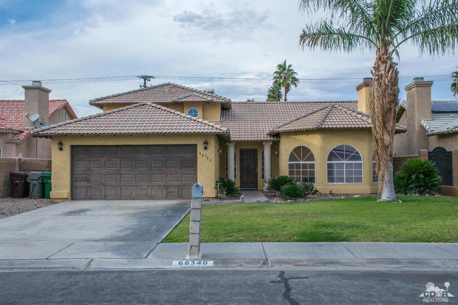 68340 Tortuga Road Cathedral City, CA 92234 - Photo 3 of 37 a front view of a house with a garden and plants