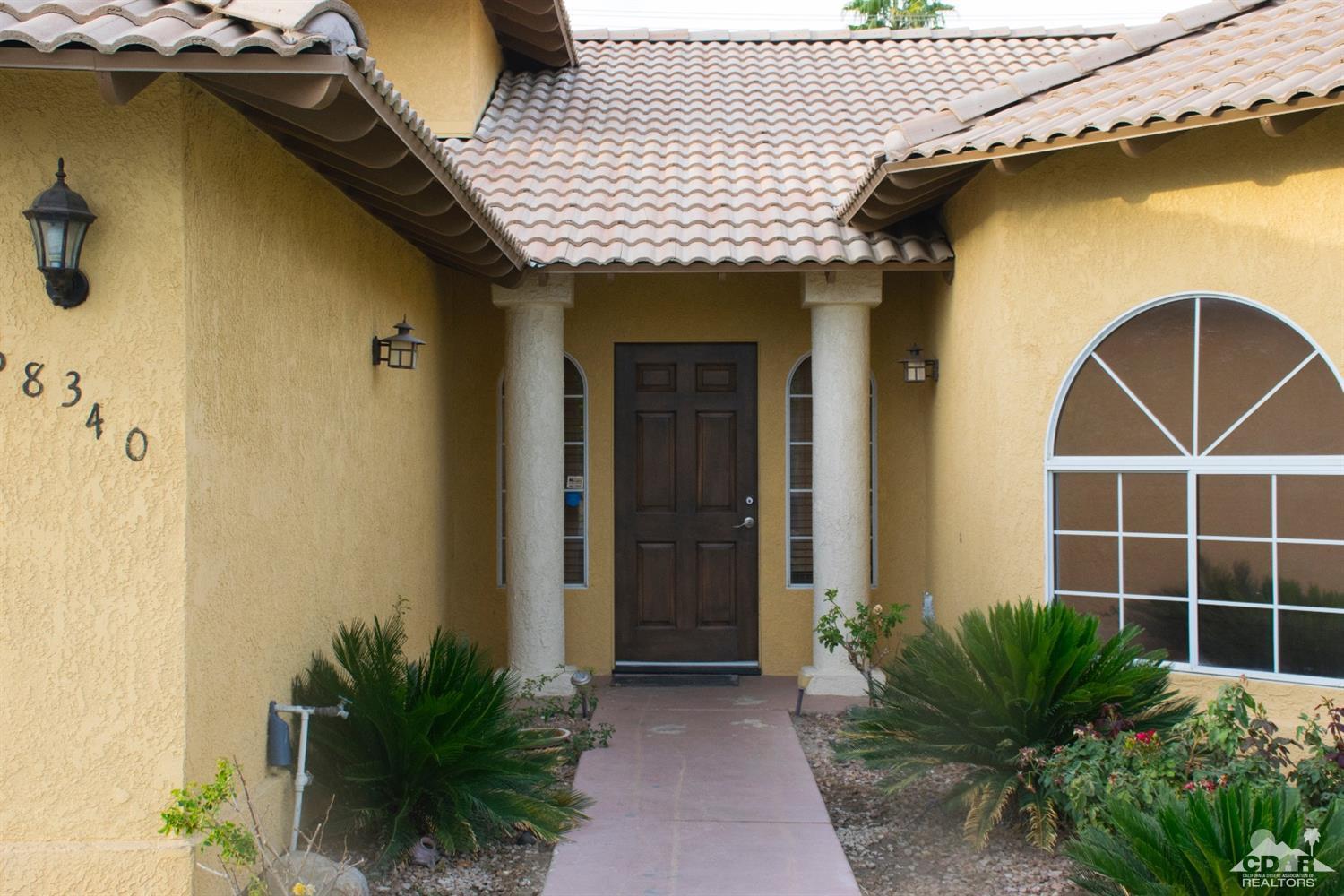 68340 Tortuga Road Cathedral City, CA 92234 - Photo 5 of 37 a front view of a house with plants