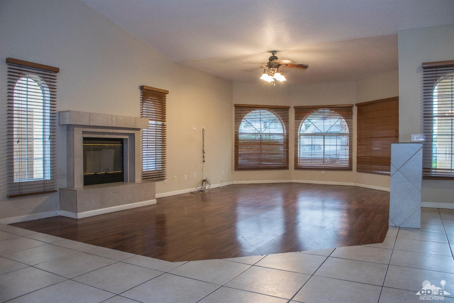 68340 Tortuga Road Cathedral City, CA 92234 - Photo 6 of 37 wooden floor in an empty room with a fireplace