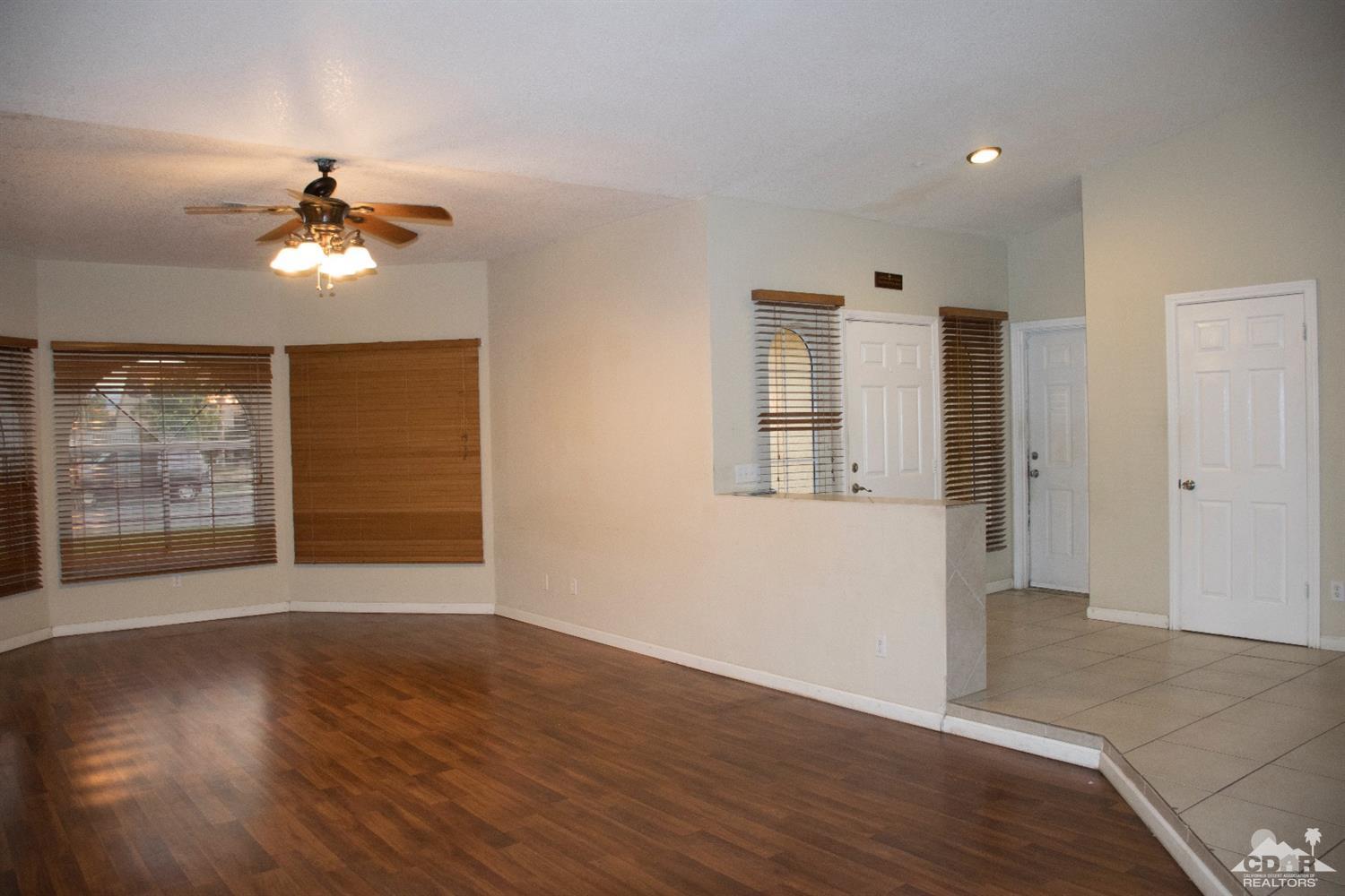 68340 Tortuga Road Cathedral City, CA 92234 - Photo 7 of 37 a view of a room with wooden floor and a ceiling fan