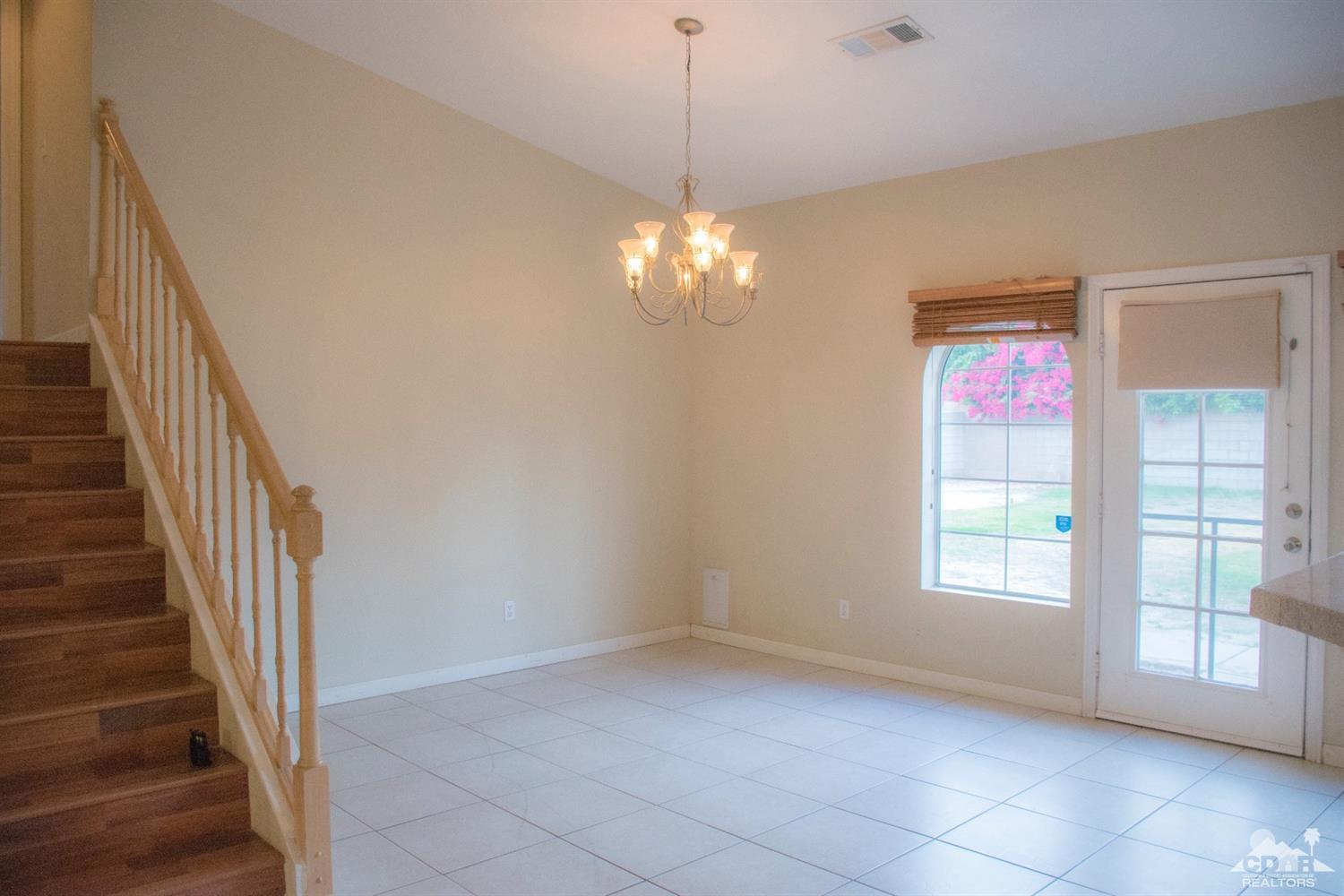 68340 Tortuga Road Cathedral City, CA 92234 - Photo 10 of 37 a view of a hallway with windows and chandelier