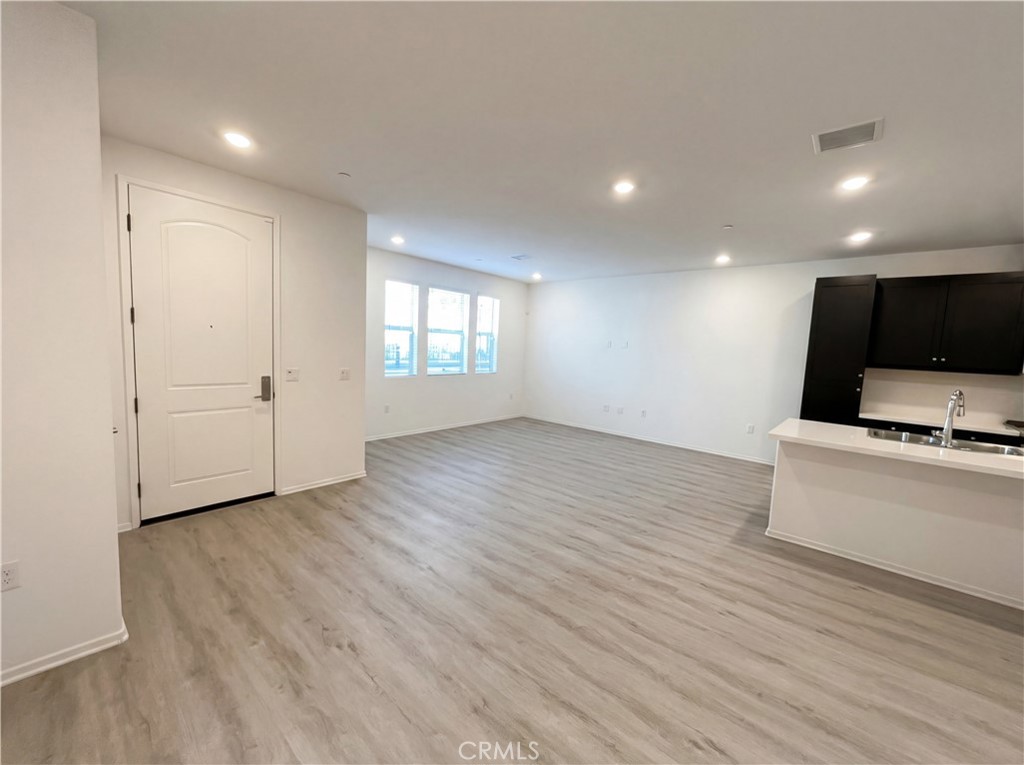 5628 Kate Way, Unit 3 Fontana, CA 92336 - Photo 11 of 20 a view of a kitchen with wooden floor and a sink