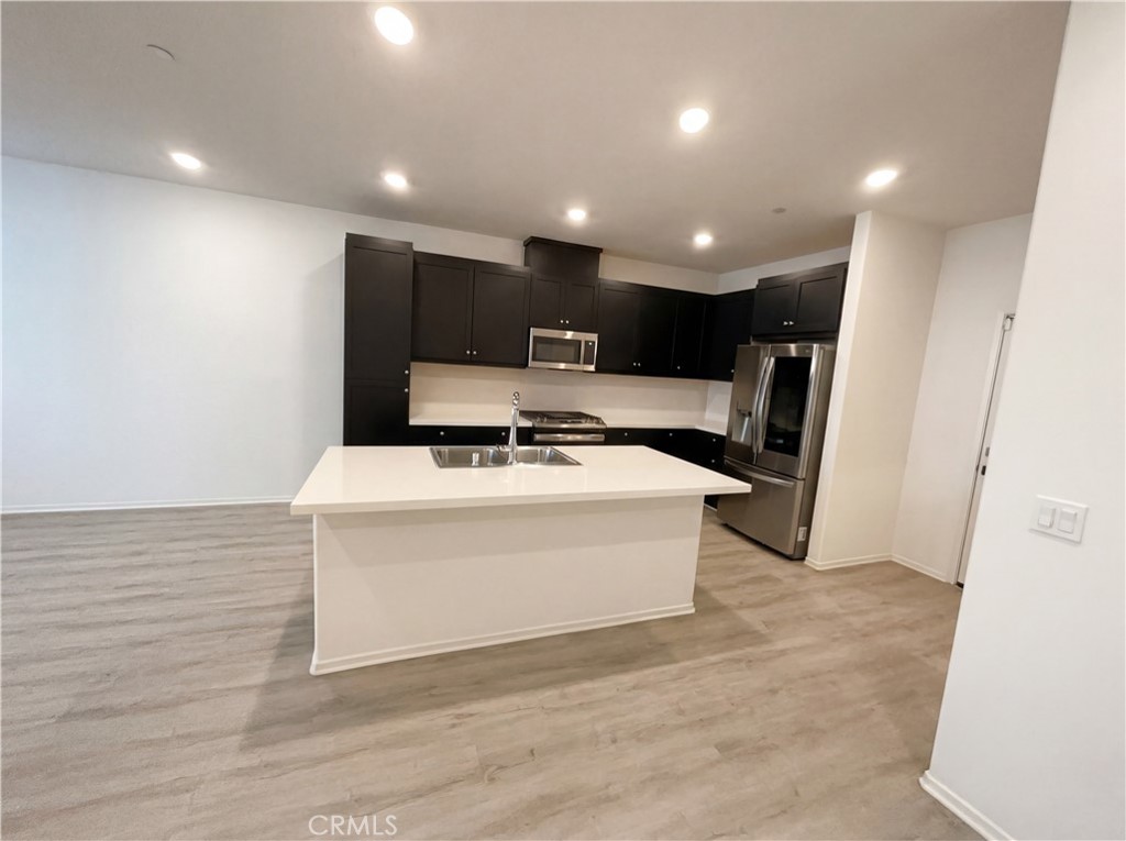 5628 Kate Way, Unit 3 Fontana, CA 92336 - Photo 2 of 20 a view of kitchen with stainless steel appliances kitchen island a sink and a refrigerator