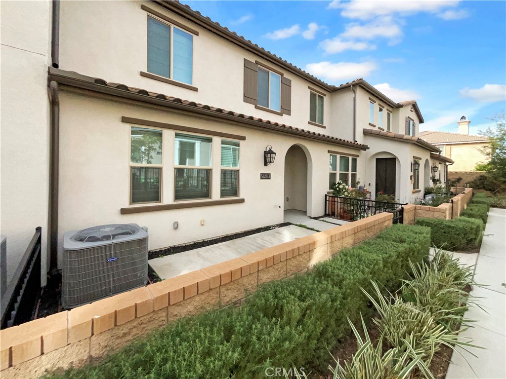 5628 Kate Way, Unit 3 Fontana, CA 92336 - Photo 6 of 20 a front view of a house with a yard