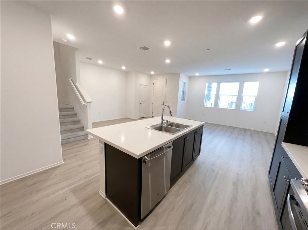 5628 Kate Way, Unit 3 Fontana, CA 92336 - Photo 8 of 20 a kitchen with a sink and wooden floor