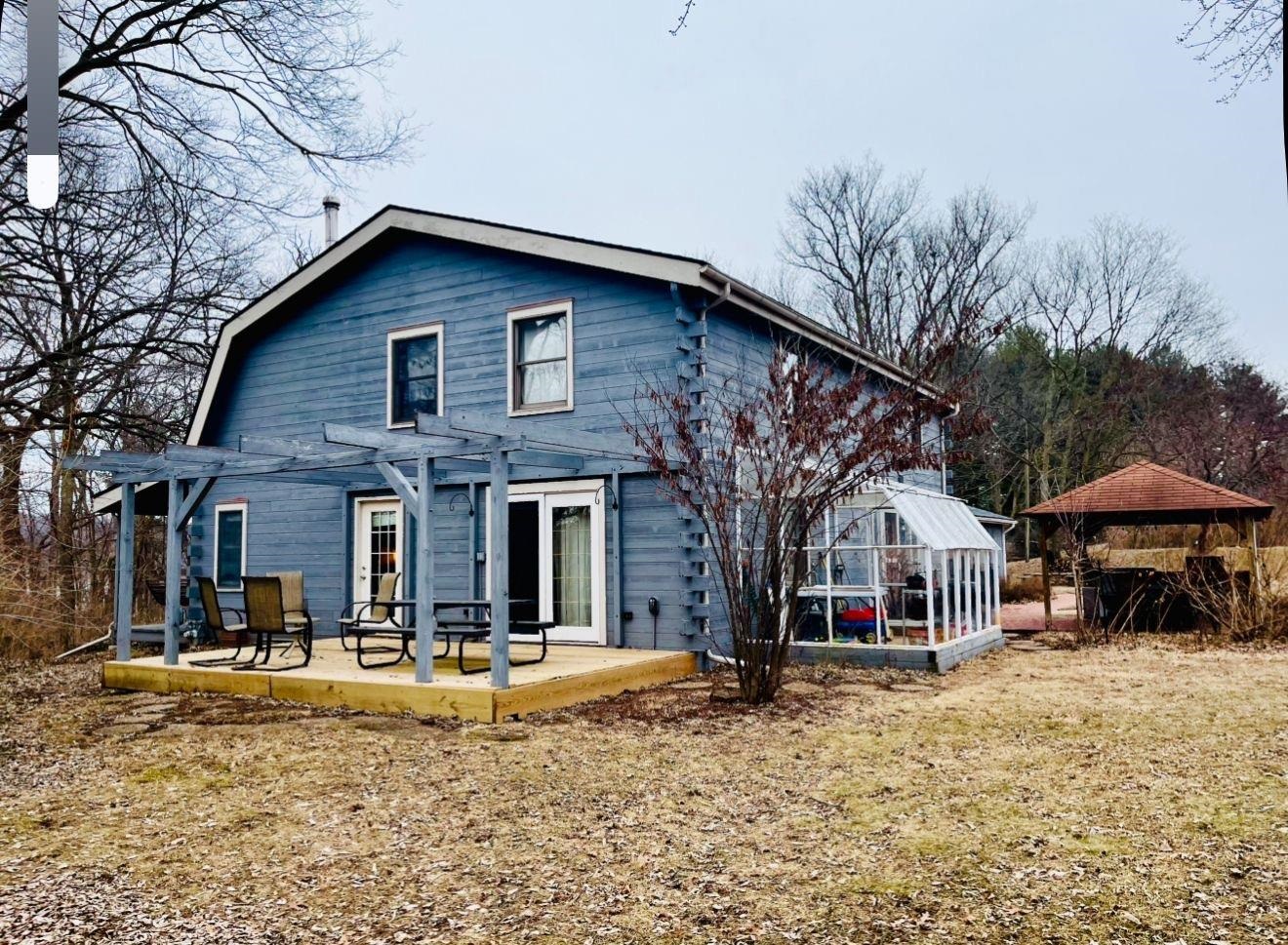 a view of a house with a yard and large tree