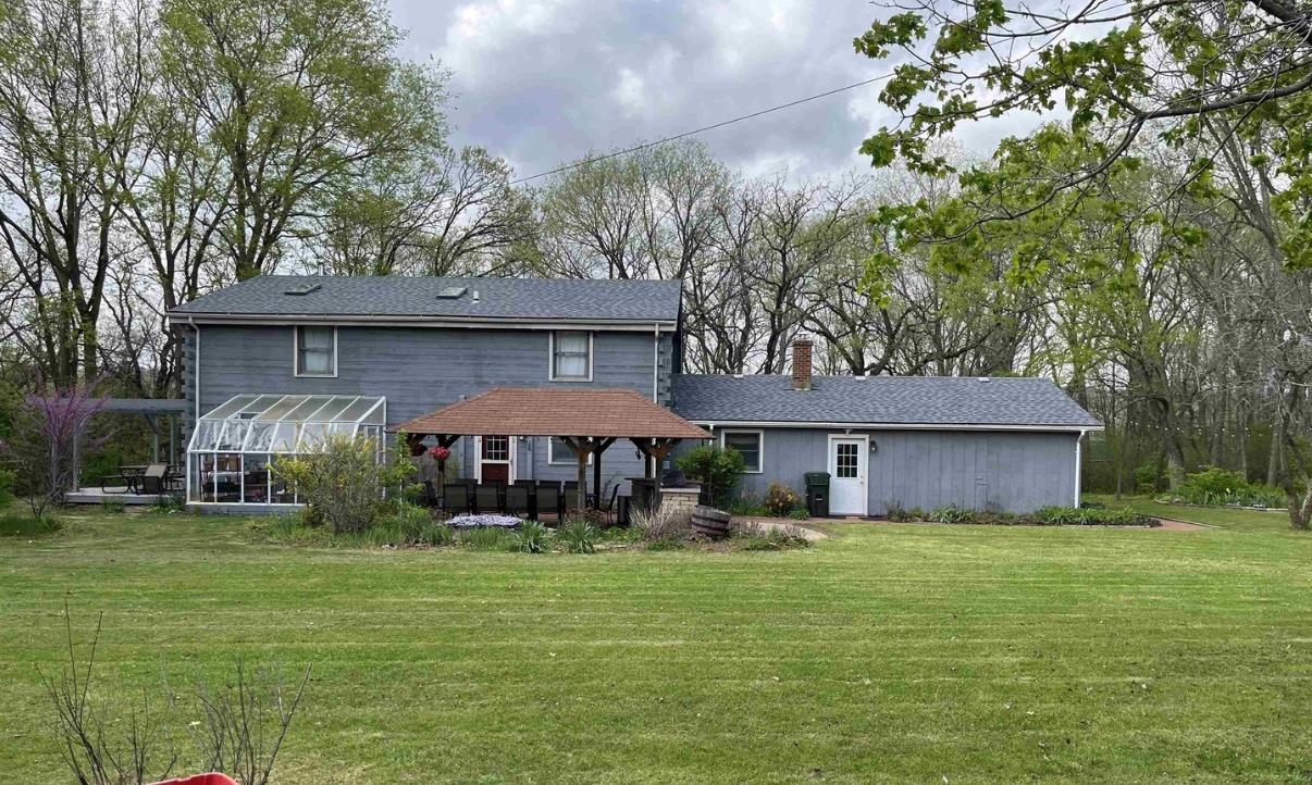 6315 North River Road Byron, IL 61010 - Photo 3 of 26 a front view of a house with garden