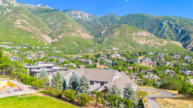 3 Carriagewood Cove, Unit 1088 Sandy, UT 84092 - Photo 5 of 79 Expansive property featuring a grey-toned residence with multiple gables, surrounded by mature evergreen trees and a paved driveway