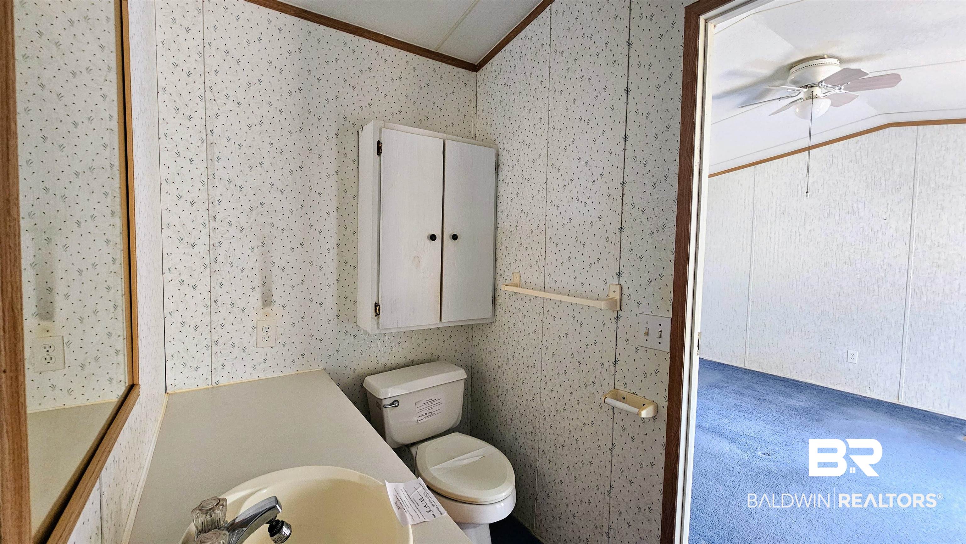 18659 Bull Springs Road Robertsdale, AL 36567 - Photo 12 of 25 Bathroom with lofted ceiling, vanity, ceiling fan, toilet, and crown molding