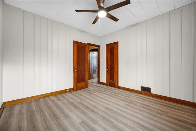 a view of an empty room with wooden floor