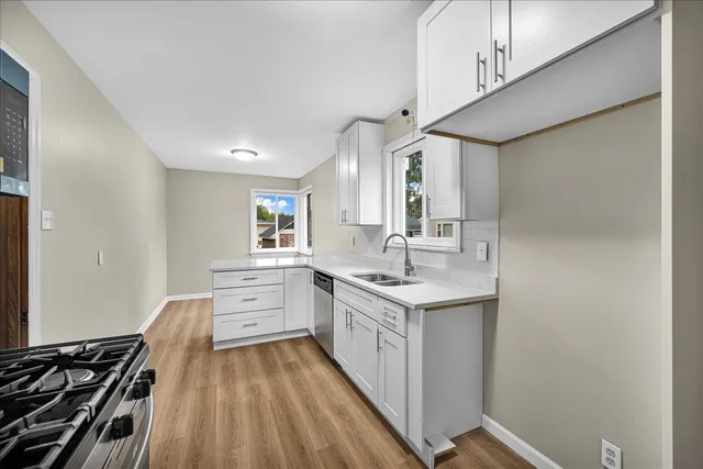 a kitchen with a sink stove and cabinets