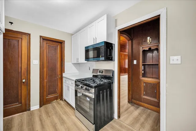 a kitchen with stainless steel appliances granite countertop a stove and a refrigerator