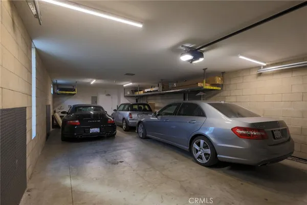 a view of parking garage with cars parked