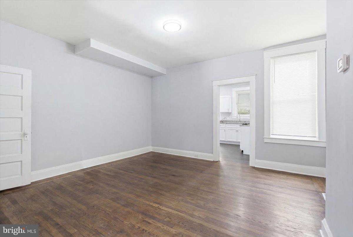 1231 North Potomac Street Baltimore, MD 21213 - Photo 6 of 25 an empty room with wooden floor and windows