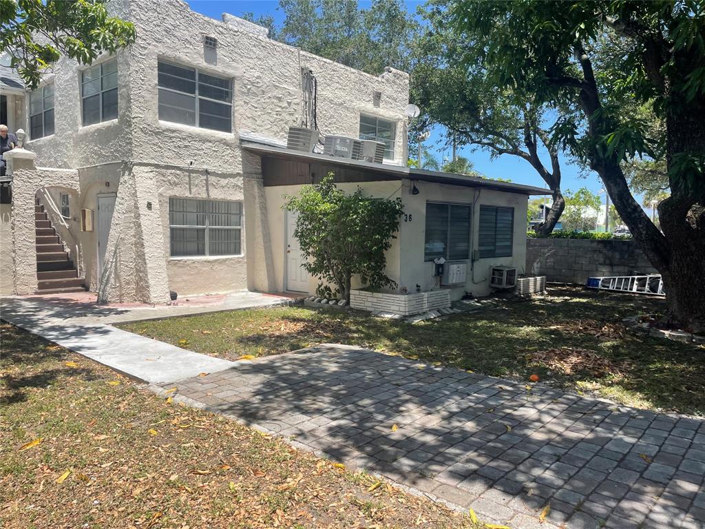 36 Southwest 14th Street, Unit 2 Dania Beach, FL 33004 - Photo 1 of 6 a view of a house with backyard and trees