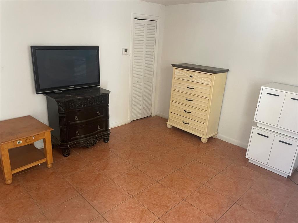 36 Southwest 14th Street, Unit 2 Dania Beach, FL 33004 - Photo 4 of 6 a view of an empty room with furniture and a flat screen tv