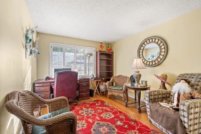 a living room with furniture a rug and a window