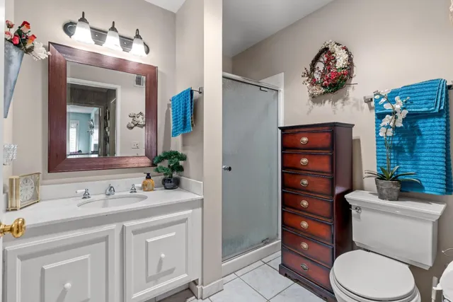 a bathroom with a sink vanity mirror and toilet