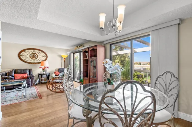 a view of a livingroom with furniture window and hardwood floor