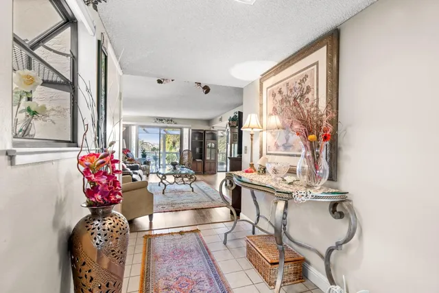 a living room with furniture and flowers