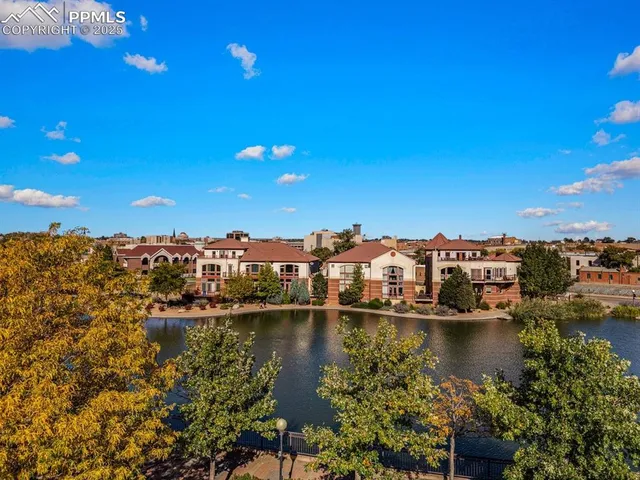 a view of residential houses with outdoor space and lake view