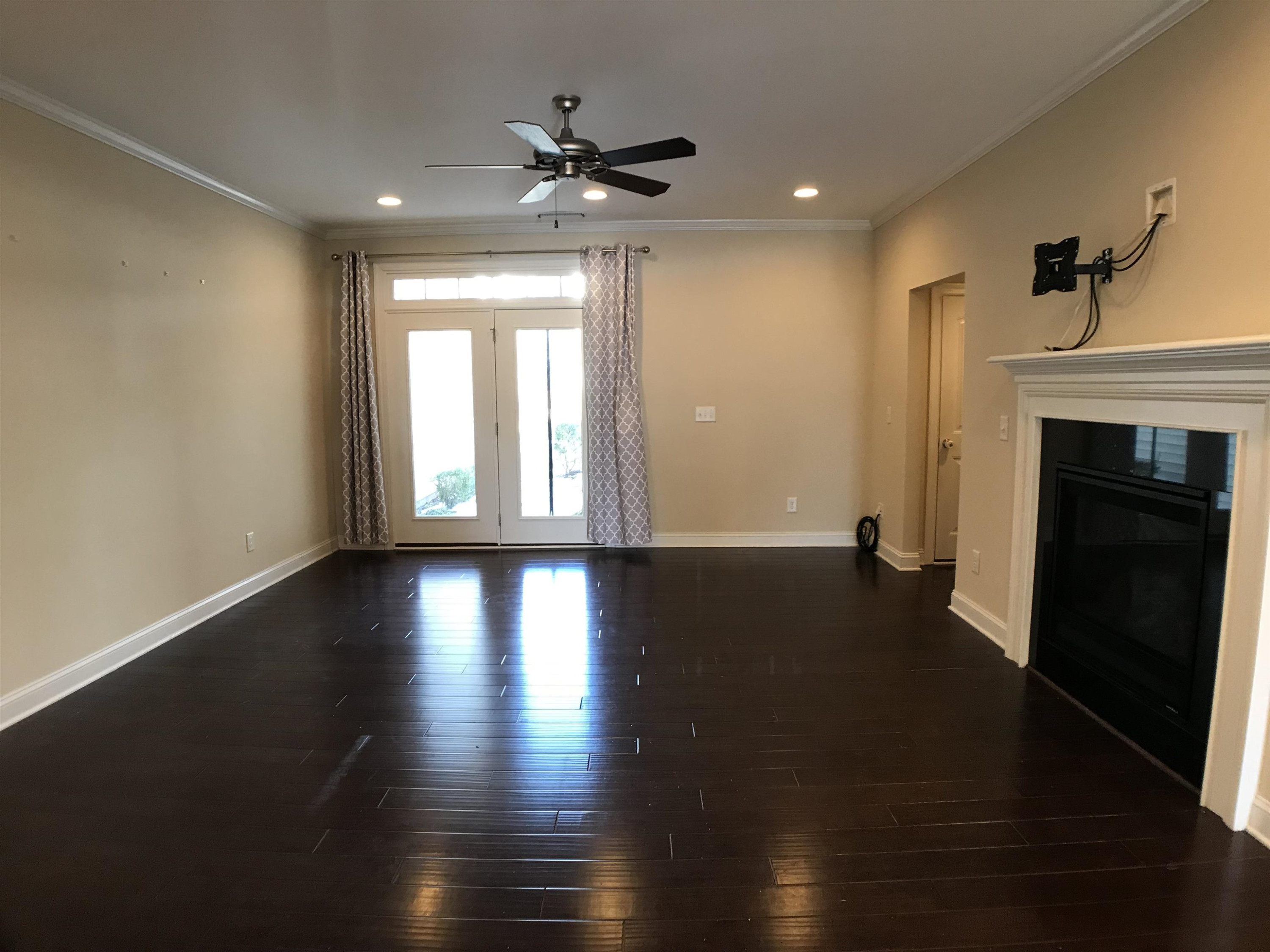 925 Rosepine Drive Cary, NC 27519 - Photo 2 of 21 an empty room with wooden floor fireplace and windows