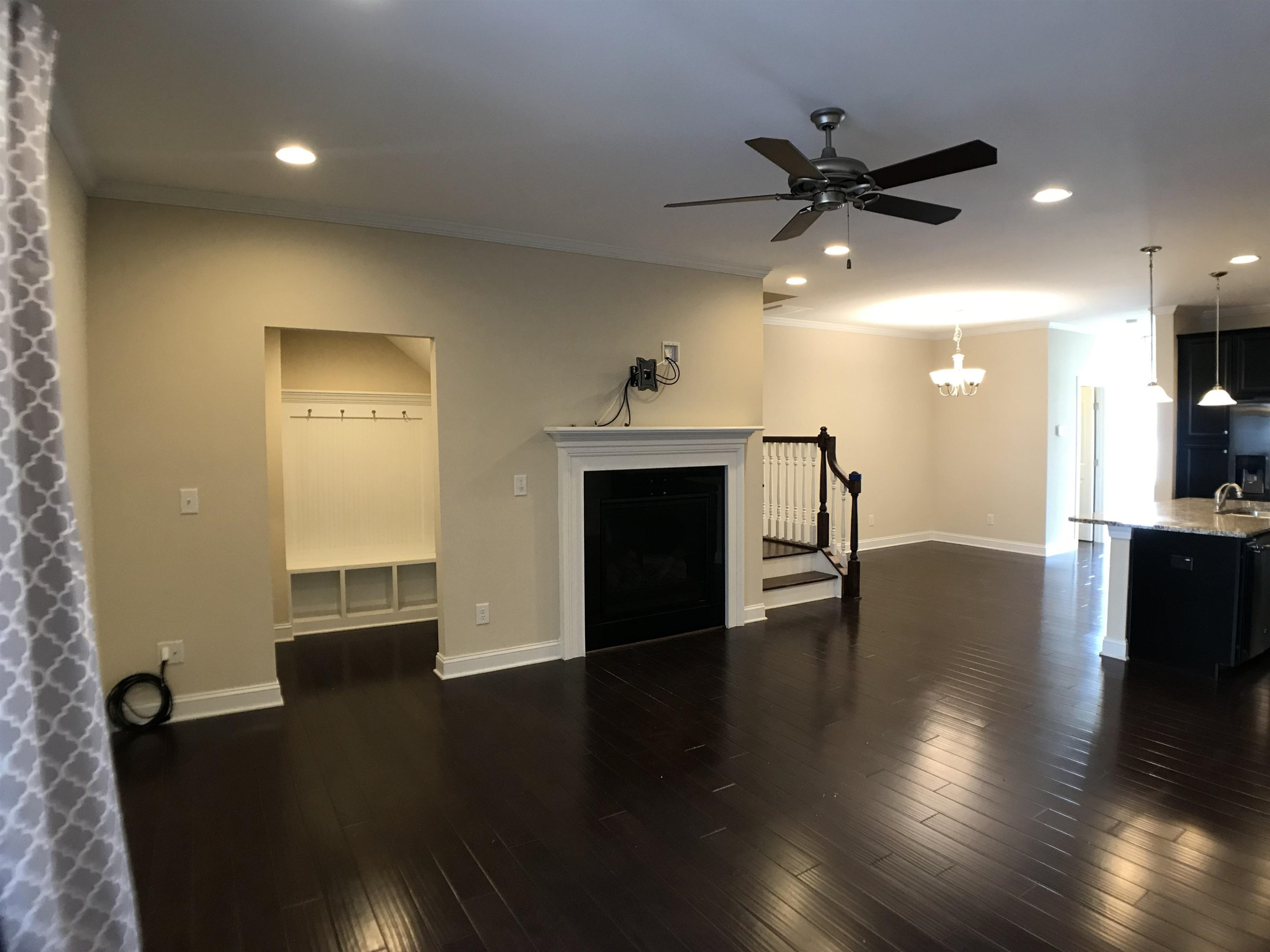 925 Rosepine Drive Cary, NC 27519 - Photo 4 of 21 a view of a livingroom with a fireplace a ceiling fan and wooden floor