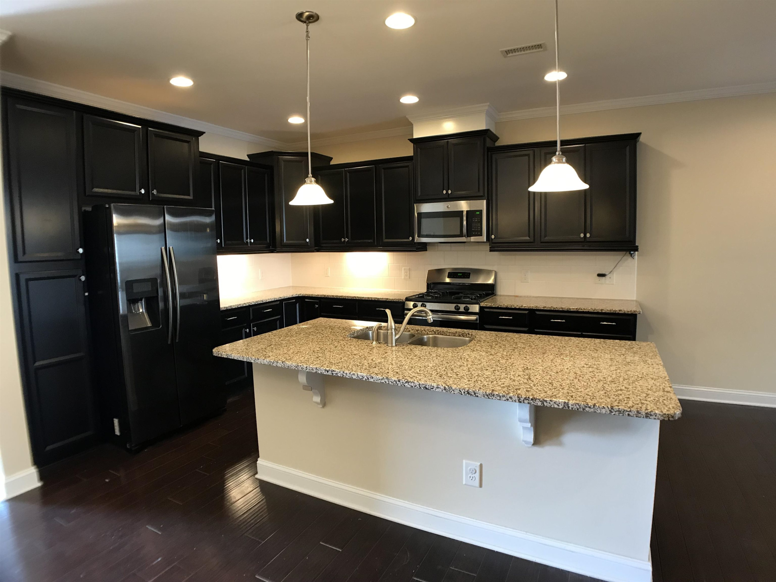 925 Rosepine Drive Cary, NC 27519 - Photo 6 of 21 a kitchen with kitchen island a sink stainless steel appliances and a refrigerator