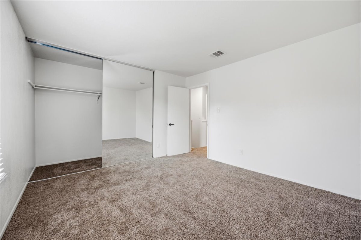 41 Abbey Road Euless, TX 76039 - Photo 21 of 23 Plush carpeting and mirrored sliding closet doors define this functional bedroom space.