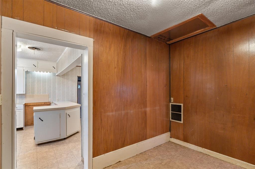 302 West Grogan Street Hamilton, TX 76531 - Photo 17 of 33 Unfurnished room with light floors and a textured ceiling