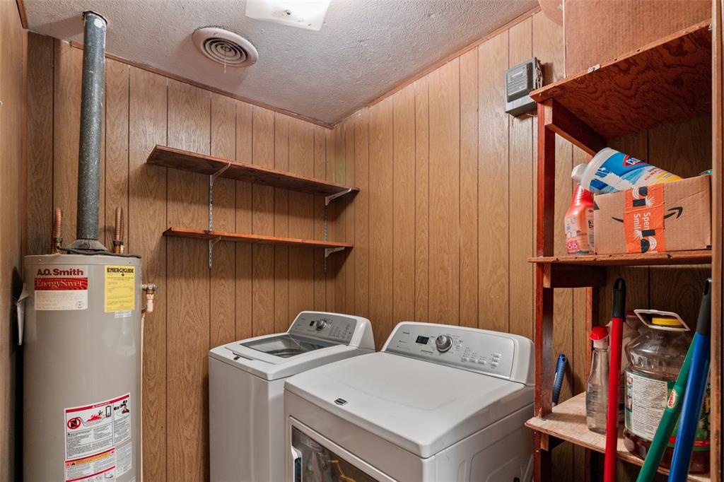 302 West Grogan Street Hamilton, TX 76531 - Photo 20 of 33 Laundry area featuring laundry area, a textured ceiling, gas water heater, and separate washer and dryer