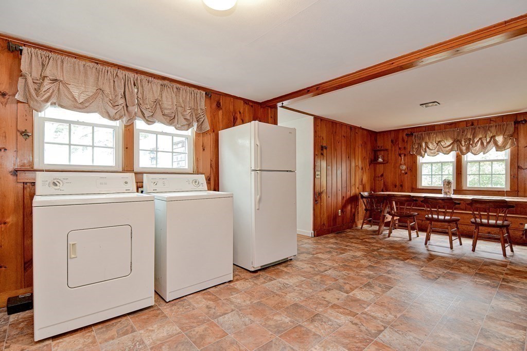 27 Naushon Road Dennis, MA 02639 - Photo 11 of 31 a kitchen with a refrigerator and a table