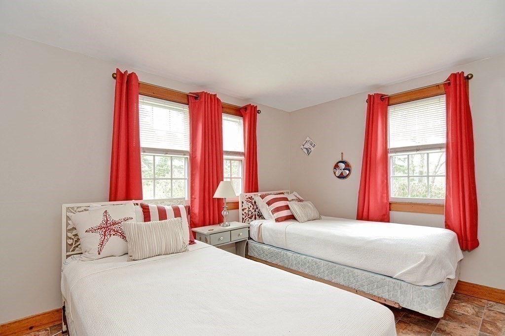 27 Naushon Road Dennis, MA 02639 - Photo 12 of 31 a bedroom with a bed and a large window