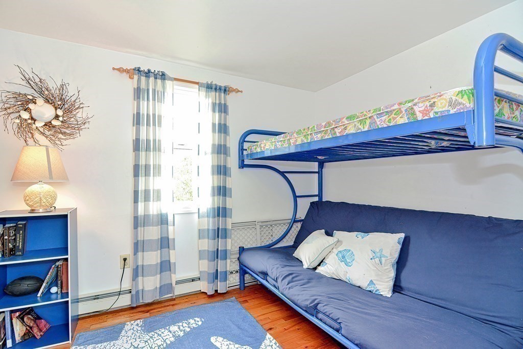 27 Naushon Road Dennis, MA 02639 - Photo 14 of 31 a living room with furniture and a bookshelf