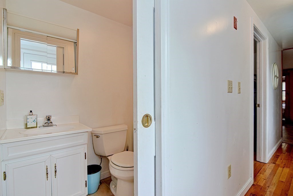 27 Naushon Road Dennis, MA 02639 - Photo 17 of 31 a white toilet sitting next to a bathroom sink