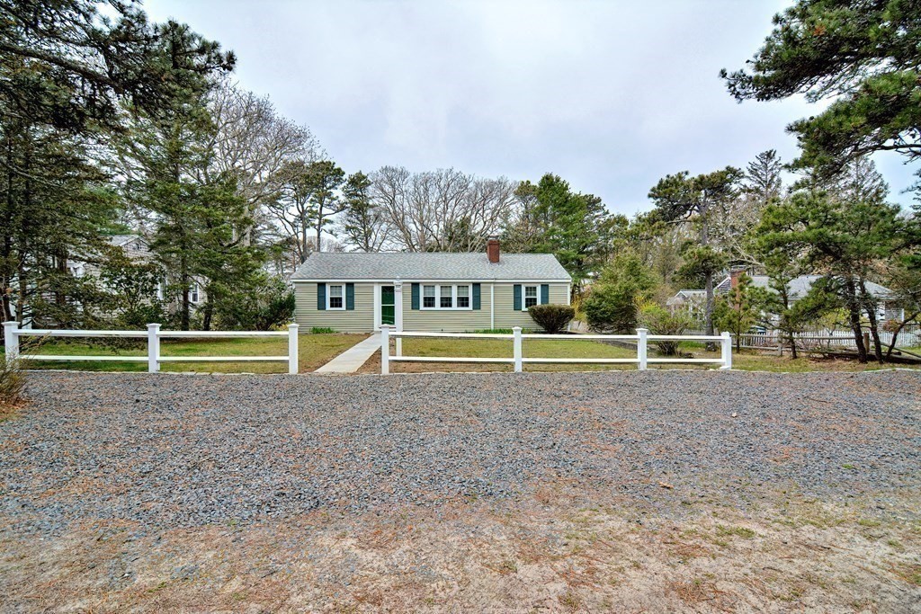 27 Naushon Road Dennis, MA 02639 - Photo 25 of 31 a view of a dry yard with a trees