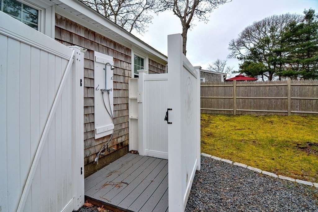 27 Naushon Road Dennis, MA 02639 - Photo 26 of 31 a view of a balcony with wooden floor and fence