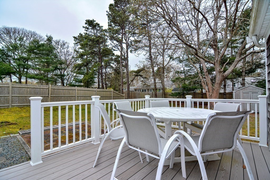 27 Naushon Road Dennis, MA 02639 - Photo 27 of 31 a view of a chair and table on the wooden floor