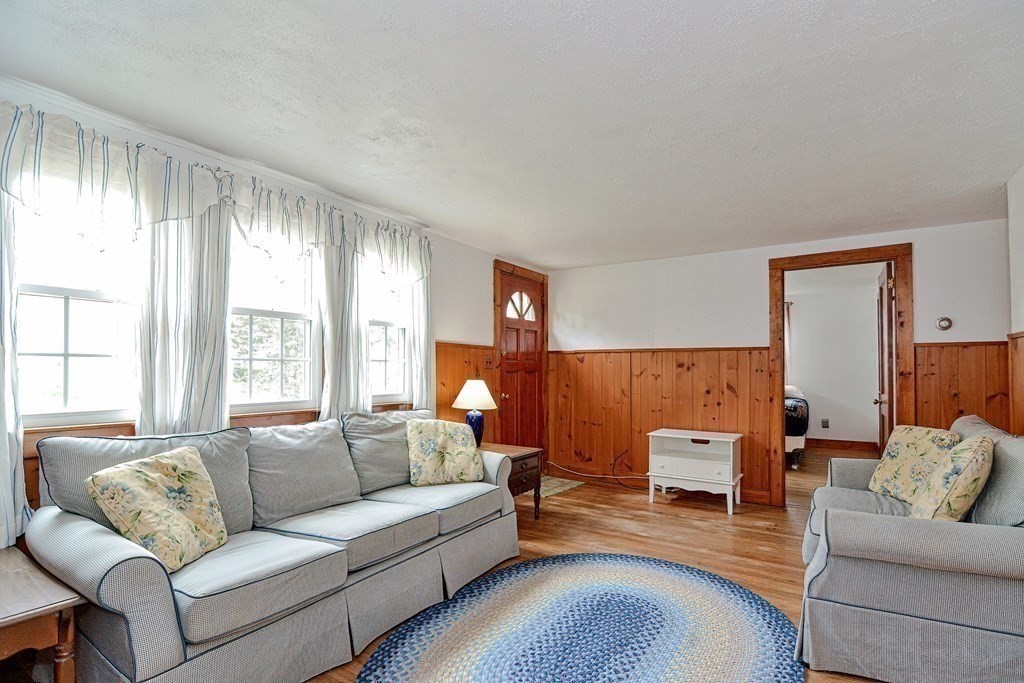 27 Naushon Road Dennis, MA 02639 - Photo 3 of 31 a living room with furniture and a large window