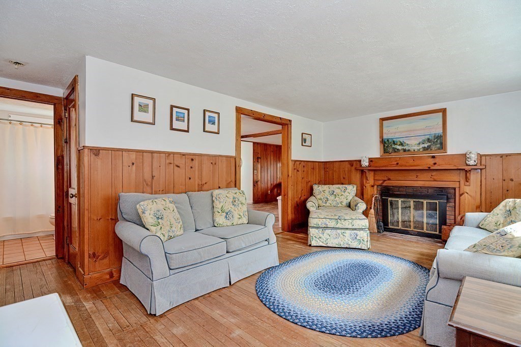 27 Naushon Road Dennis, MA 02639 - Photo 5 of 31 a living room with furniture and a fireplace