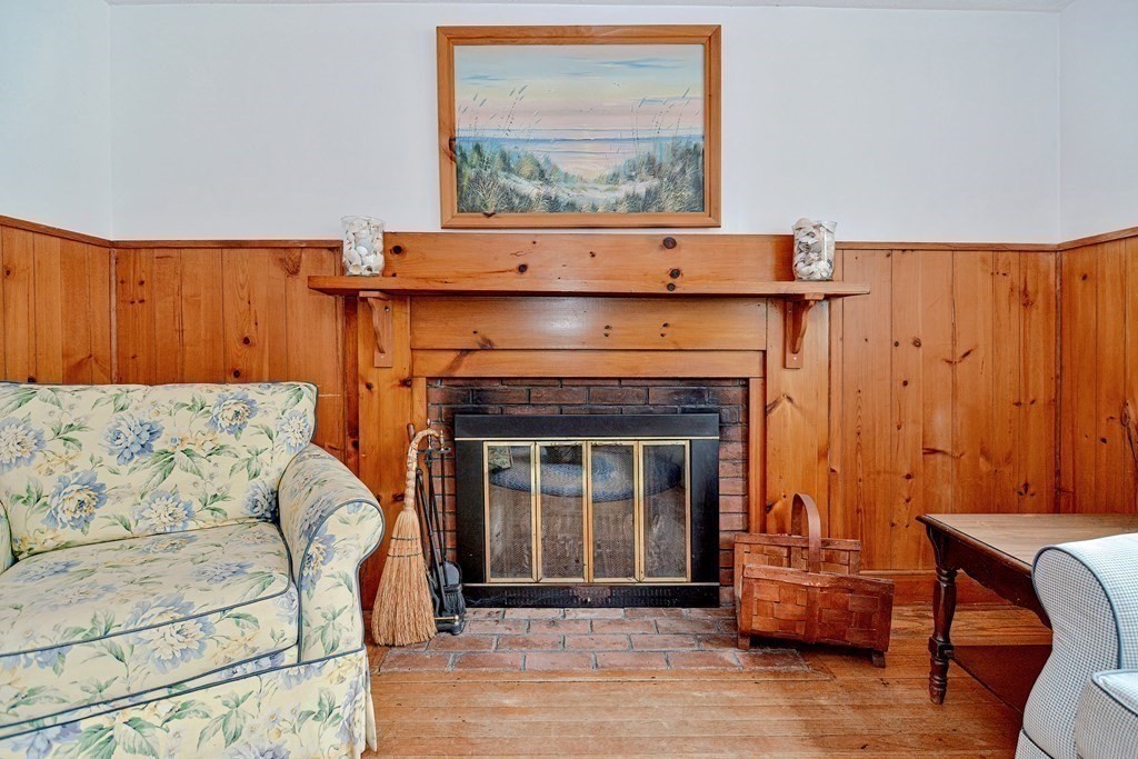 27 Naushon Road Dennis, MA 02639 - Photo 6 of 31 a living room with furniture and a fireplace