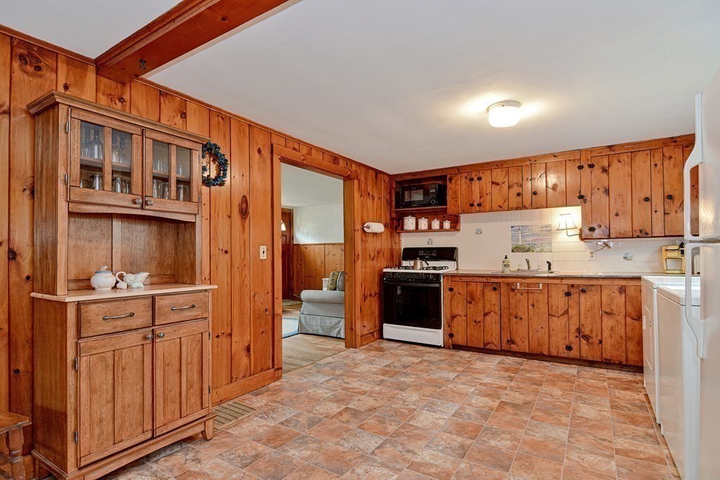 27 Naushon Road Dennis, MA 02639 - Photo 8 of 31 a kitchen with stainless steel appliances a refrigerator and wooden cabinets