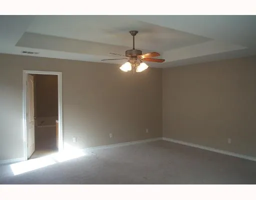 a view of a livingroom with a chandelier fan