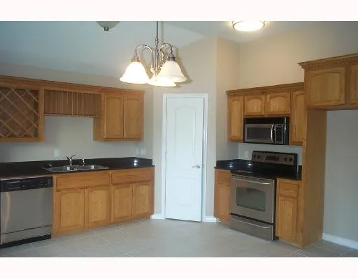 a kitchen with stainless steel appliances a stove a sink and a refrigerator