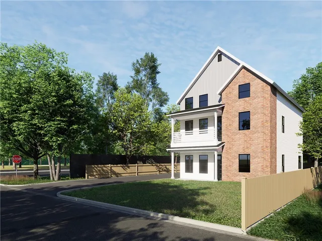 a view of a yard in front of a house with large windows