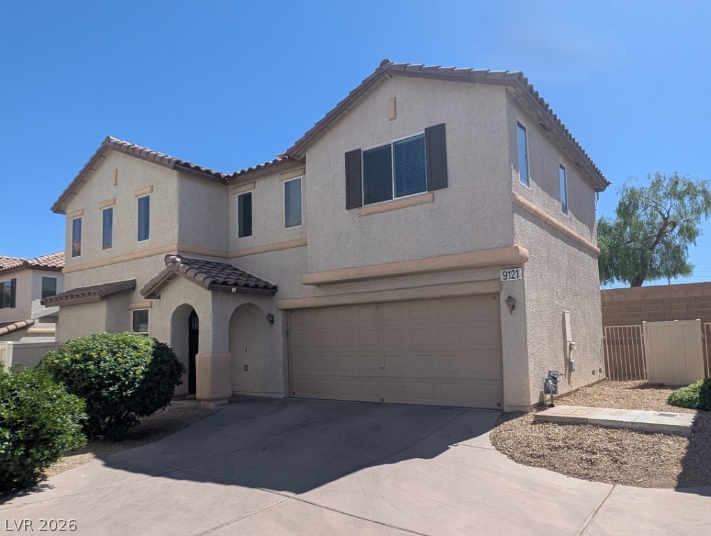9121 Spoonbill Ridge Place Las Vegas, NV 89143 - Photo 1 of 26 A well-maintained facade with an integrated garage and welcoming entry.