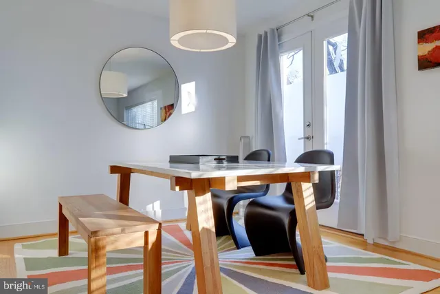 a living room with furniture and a mirror